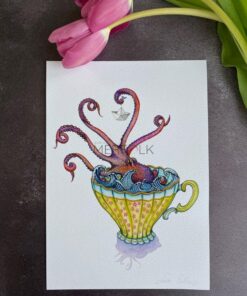 purple kraken holding a paper boat in a vintage teacup